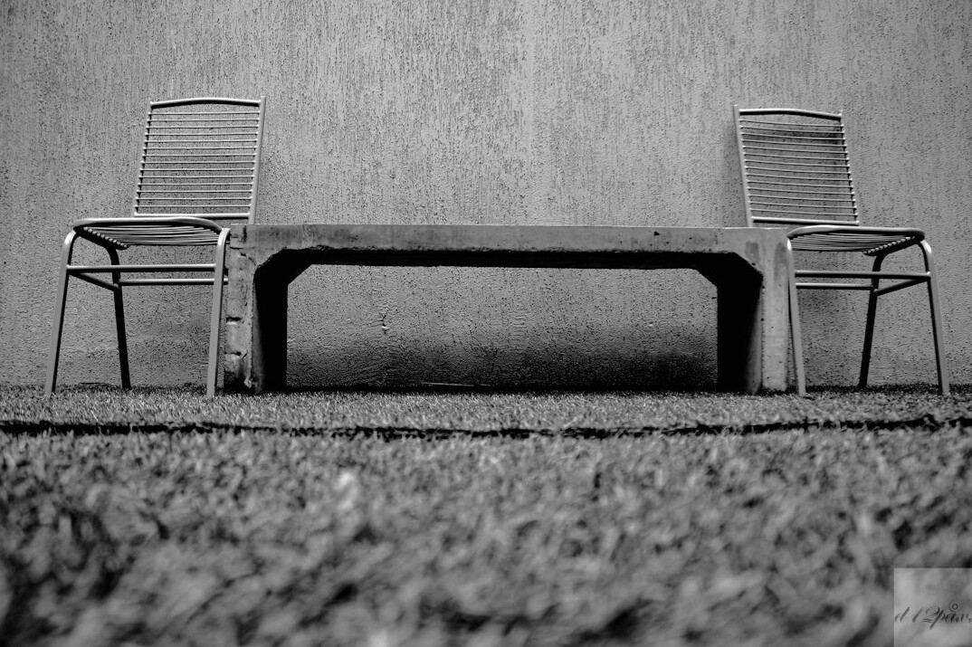 Empty panel discussion table with microphones and name placards